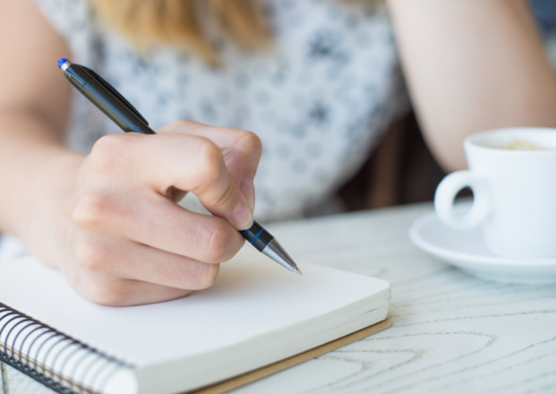 A person writing in her notebook