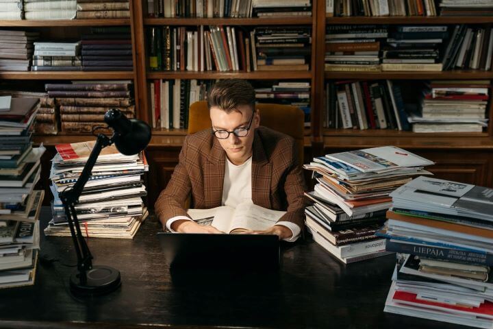 A man with a stack of books